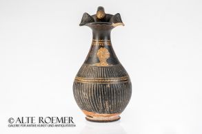 Large oinochoe decorated with female bust and lion head