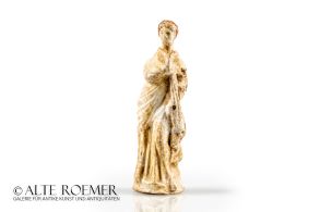 Tanagra figurine of a standing woman with partially preserved painting