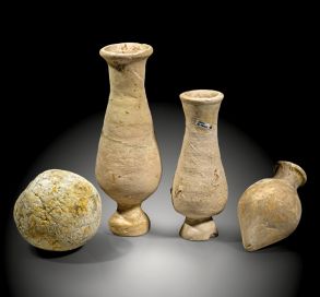 Three Roman pottery amphora plugs and one stone projectile from the Rhineland
